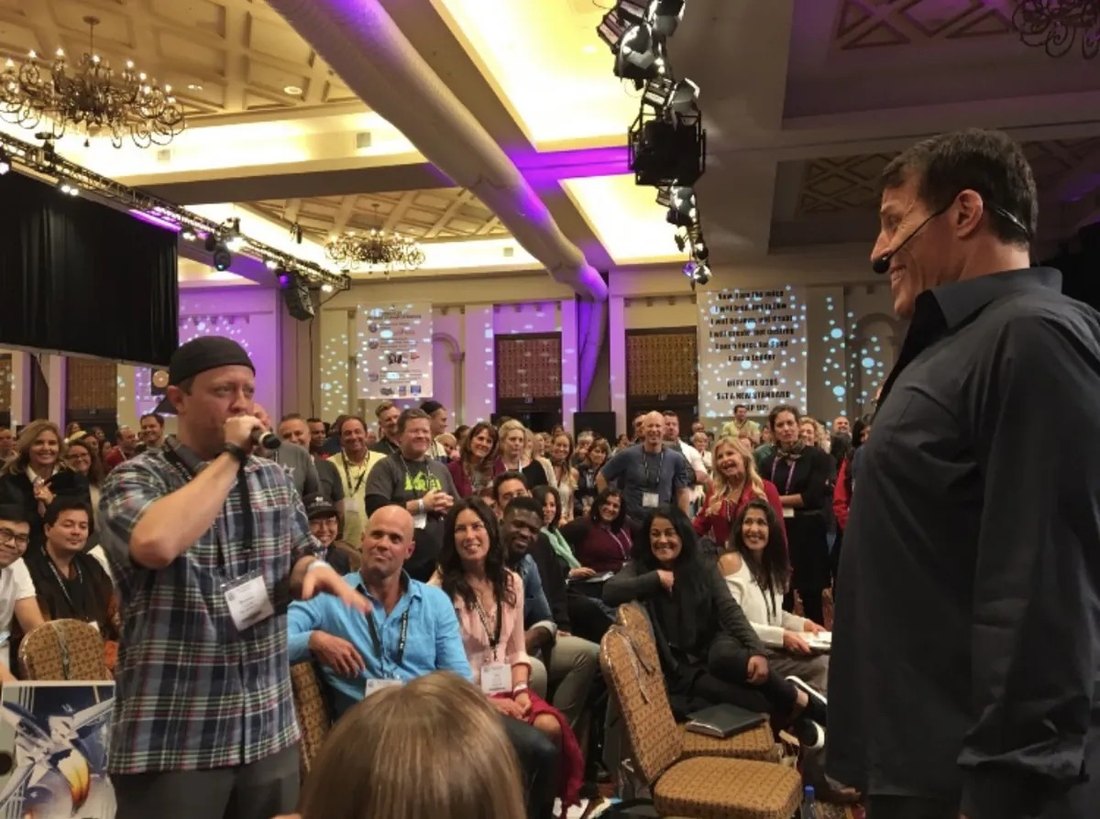Brayson Verzella on stage with Tony Robbins at a Date with Destiny event